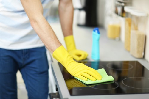 Office cleaner preparing a clean and tidy workspace in E8
